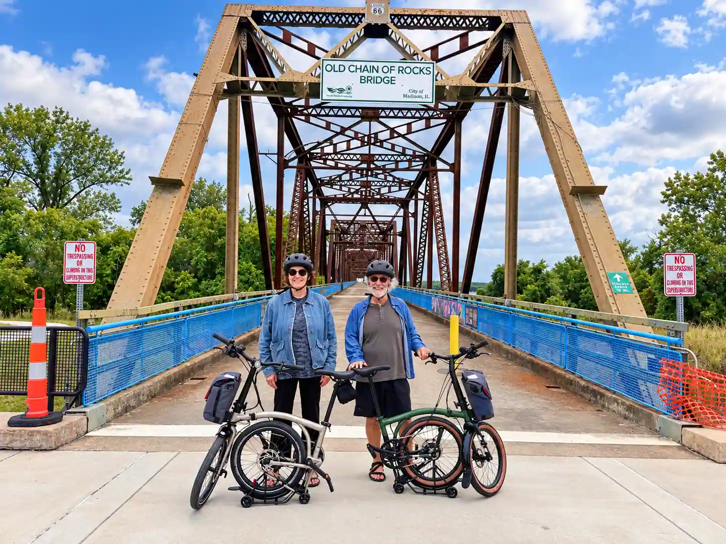 Two eBike NOLA customers with their Brompton Electric G Line bicycles at the Old Chain of Rocks Bridge over the Mississippi River